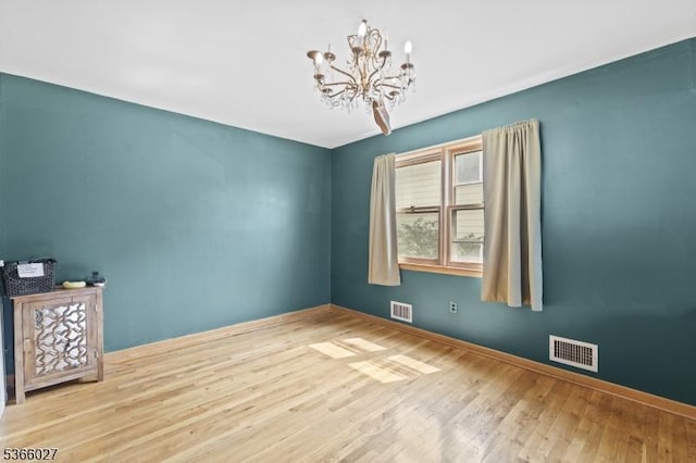132 N 17th St, Prospect Park Boro, NJ 07508 - spare room with wood finished floors and a chandelier