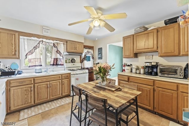 132 N 17th St, Prospect Park Boro, NJ 07508 - kitchen with white gas stove, light countertops, ceiling fan, and brown cabinets