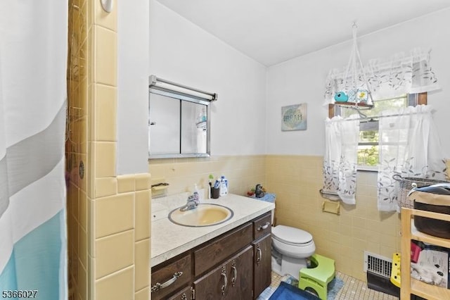 132 N 17th St, Prospect Park Boro, NJ 07508 - bathroom with tile walls, vanity, tile patterned floors, and wainscoting