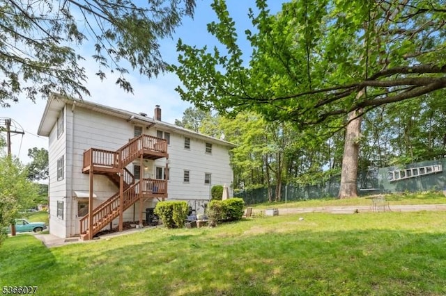 132 N 17th St, Prospect Park Boro, NJ 07508 - rear view of property with stairway, a chimney, and a deck