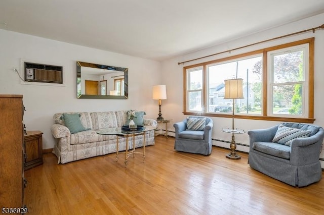10 Springdale Gardens Rd, Andover Twp, NJ 07860 - living room featuring a wall mounted AC, wood finished floors, and baseboard heating