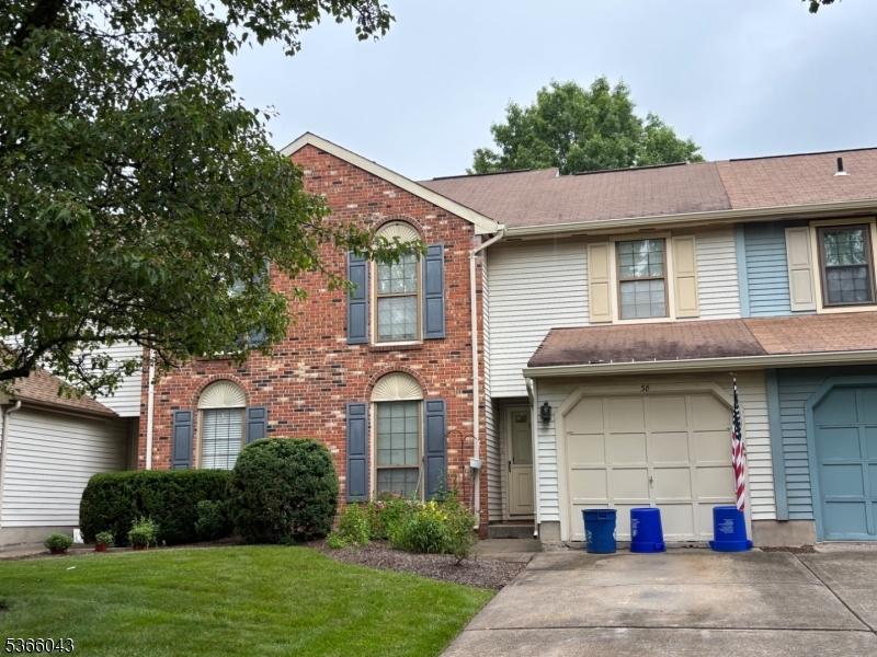 38 Fox Hill Ln, Hillsborough Twp, NJ 08844 - townhome / multi-family property featuring concrete driveway, a front lawn, brick siding, and a garage