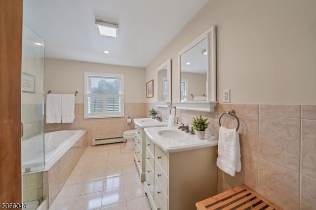 202 N Rd, Chester Twp, NJ 07930 - bathroom with a baseboard heating unit, tile patterned flooring, vanity, a garden tub, and tile walls