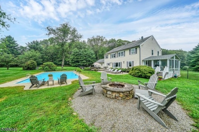 202 N Rd, Chester Twp, NJ 07930 - outdoor pool featuring a fire pit, a sunroom, a patio, a lawn, and view of wooded area