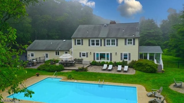 202 N Rd, Chester Twp, NJ 07930 - rear view of house featuring a patio area, an outdoor pool, and a chimney