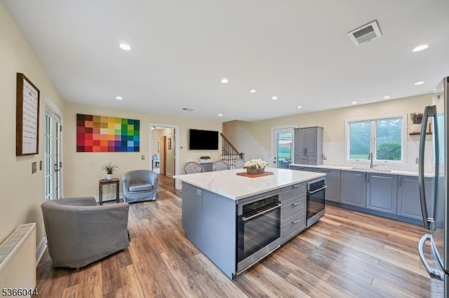 202 N Rd, Chester Twp, NJ 07930 - kitchen with radiator heating unit, gray cabinets, appliances with stainless steel finishes, open floor plan, and light countertops