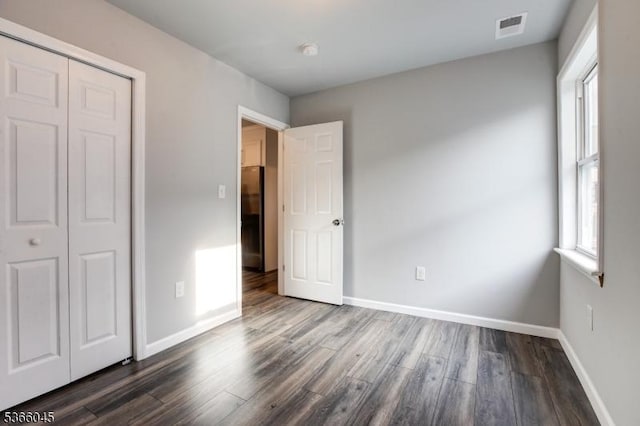 23 Howard St, Irvington Twp, NJ 07111 - unfurnished bedroom featuring dark wood finished floors, a closet, and fridge
