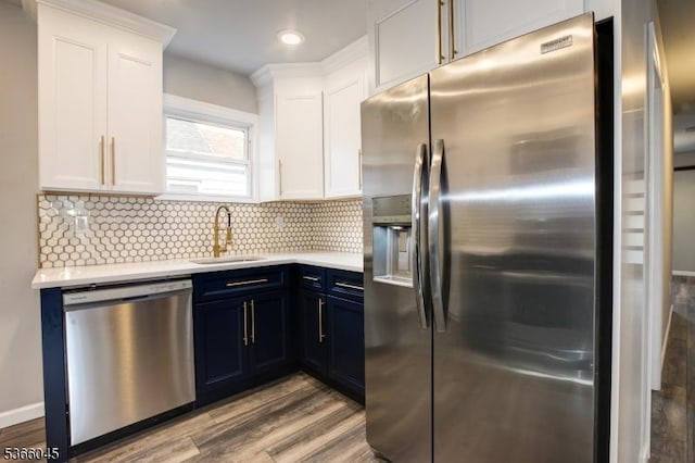 23 Howard St, Irvington Twp, NJ 07111 - kitchen with appliances with stainless steel finishes, light countertops, wood finished floors, white cabinets, and recessed lighting
