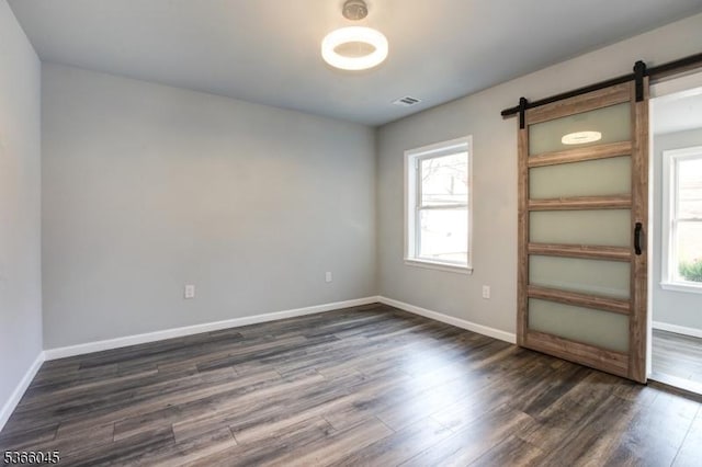 23 Howard St, Irvington Twp, NJ 07111 - empty room with dark wood finished floors and a barn door