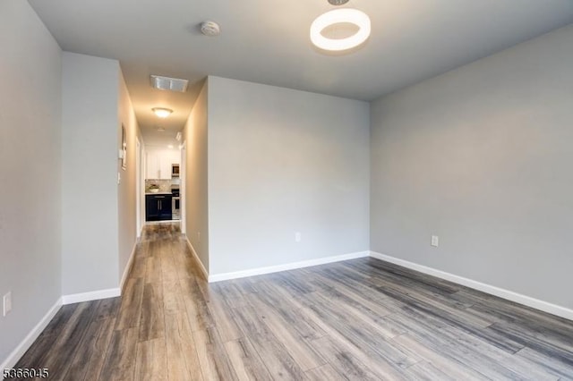 23 Howard St, Irvington Twp, NJ 07111 - spare room with wood finished floors and a smoke detector