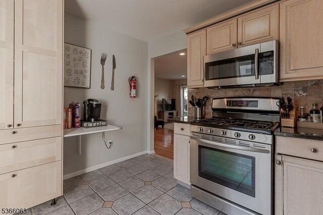 9 Cottage Ct, Berkeley Heights Twp, NJ 07922 - kitchen with appliances with stainless steel finishes, backsplash, light tile patterned floors, light brown cabinets, and dark countertops