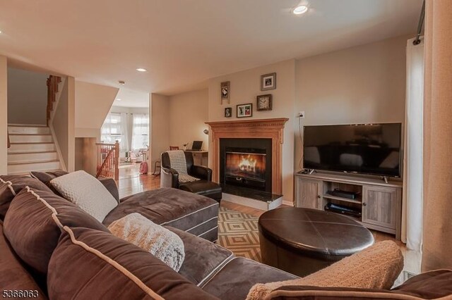9 Cottage Ct, Berkeley Heights Twp, NJ 07922 - living area with a glass covered fireplace, wood finished floors, recessed lighting, and stairs
