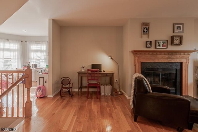 9 Cottage Ct, Berkeley Heights Twp, NJ 07922 - living area featuring wood-type flooring, recessed lighting, an upstairs landing, a glass covered fireplace, and a desk