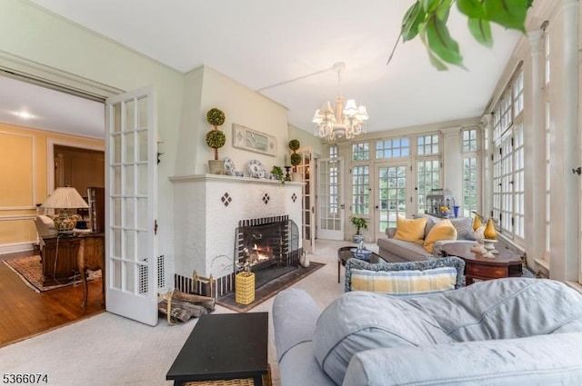 701 Hillcrest Blvd, Phillipsburg Town, NJ 08865 - living room featuring french doors, healthy amount of natural light, a fireplace, and a chandelier