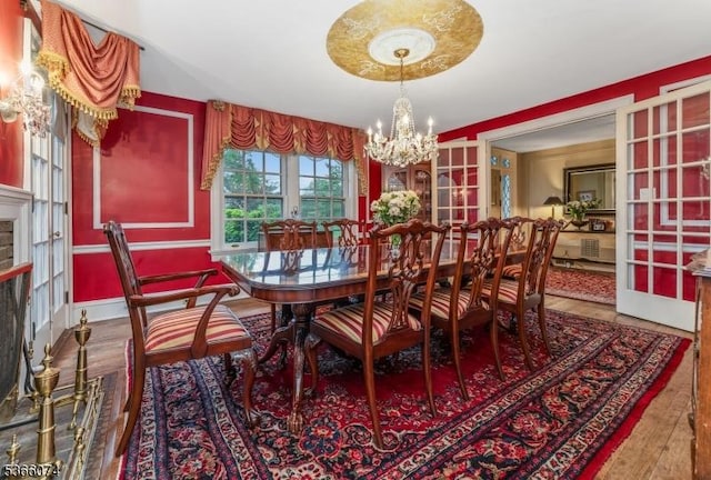 701 Hillcrest Blvd, Phillipsburg Town, NJ 08865 - dining room with a chandelier, a fireplace, wood finished floors, and french doors