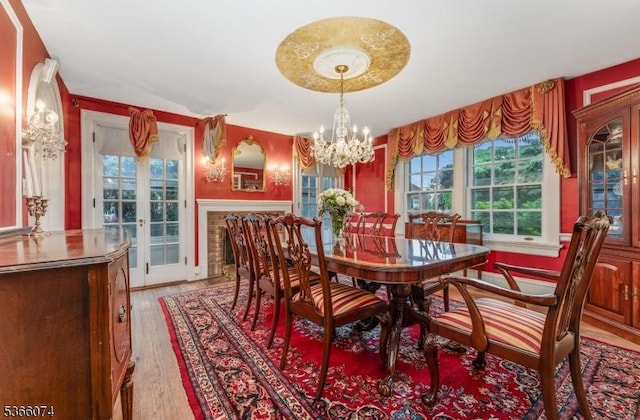 701 Hillcrest Blvd, Phillipsburg Town, NJ 08865 - dining space featuring french doors, a chandelier, plenty of natural light, and light wood-style floors