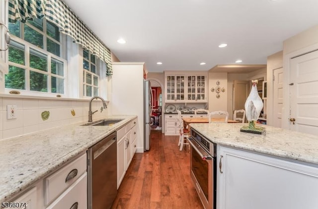 701 Hillcrest Blvd, Phillipsburg Town, NJ 08865 - kitchen with appliances with stainless steel finishes, decorative backsplash, wood finished floors, light stone countertops, and white cabinetry
