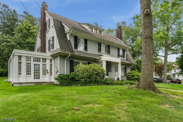 701 Hillcrest Blvd, Phillipsburg Town, NJ 08865 - view of front facade with a chimney, stucco siding, a front lawn, and a sunroom