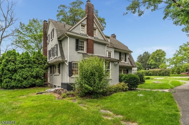 701 Hillcrest Blvd, Phillipsburg Town, NJ 08865 - view of side of home with stucco siding, a chimney, and a lawn