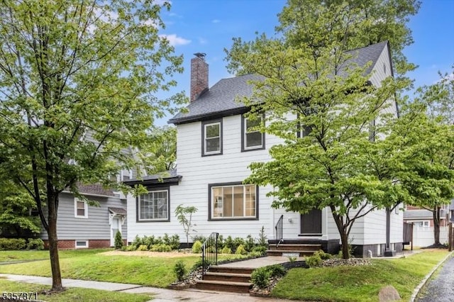121 S Kingman Rd, South Orange Village Twp, NJ 07079 - view of front of house featuring a chimney, a front yard, and a shingled roof