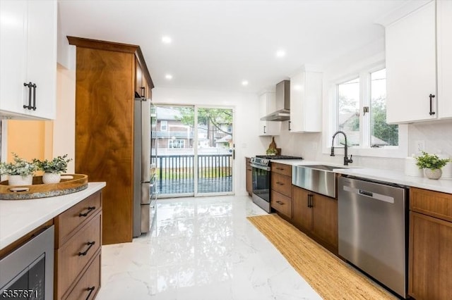 121 S Kingman Rd, South Orange Village Twp, NJ 07079 - kitchen with appliances with stainless steel finishes, wall chimney exhaust hood, light marble finish flooring, light countertops, and white cabinets