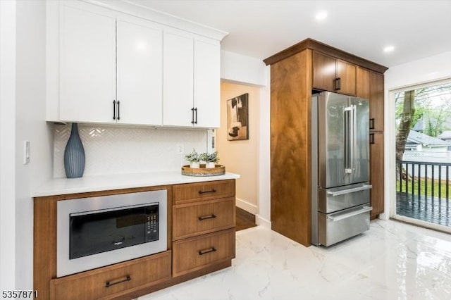 121 S Kingman Rd, South Orange Village Twp, NJ 07079 - kitchen featuring freestanding refrigerator, built in microwave, light marble finish floors, light countertops, and white cabinets