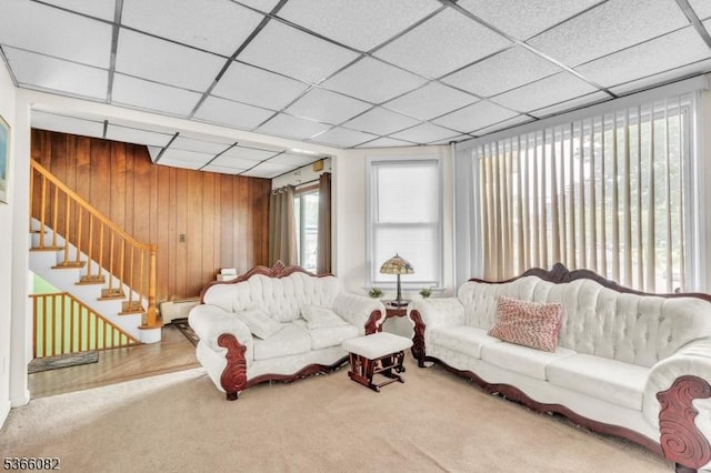 1432 Munn Ave, Hillside Twp, NJ 07205 - living area with carpet flooring, wood walls, stairs, a paneled ceiling, and a baseboard radiator