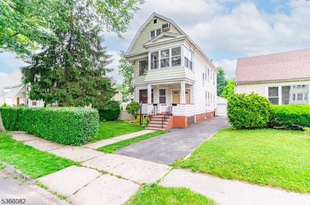 1432 Munn Ave, Hillside Twp, NJ 07205 - view of front of home featuring a front yard, a detached garage, and an outdoor structure