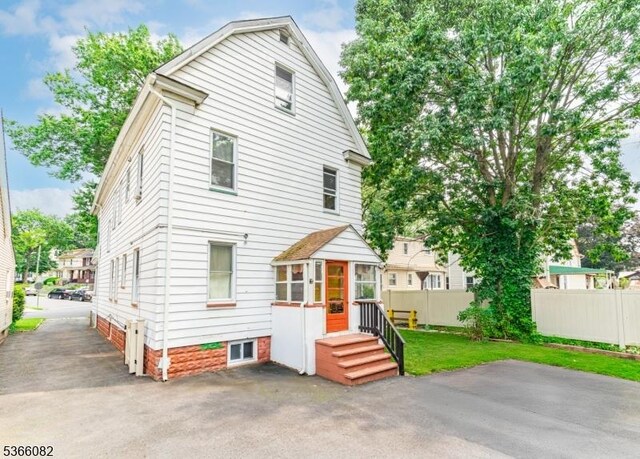 1432 Munn Ave, Hillside Twp, NJ 07205 - back of property featuring a patio and a sunroom