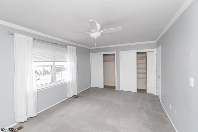 167 Riva Dr, Mansfield Twp, NJ 07840 - unfurnished bedroom featuring two closets, crown molding, carpet flooring, and ceiling fan