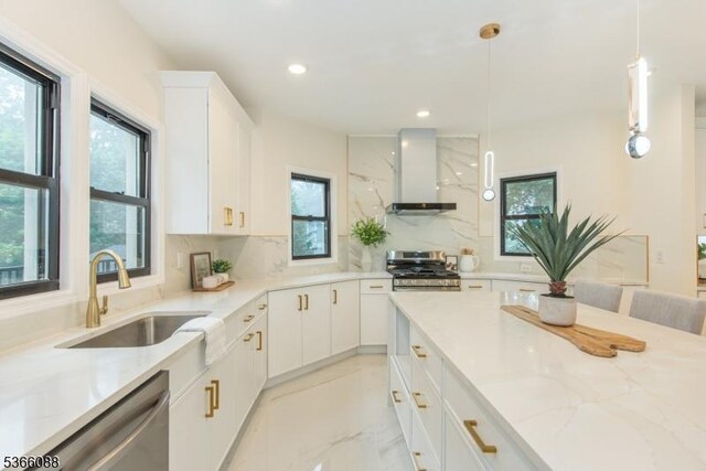 24 Hillcrest Rd, Mountain Lakes Boro, NJ 07046 - kitchen with wall chimney range hood, stainless steel appliances, light stone counters, backsplash, and decorative light fixtures