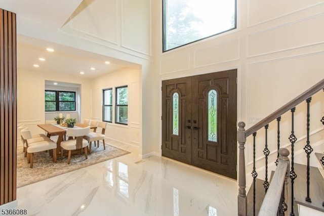 24 Hillcrest Rd, Mountain Lakes Boro, NJ 07046 - entrance foyer featuring a decorative wall, marble tiled floors, stairs, recessed lighting, and a towering ceiling