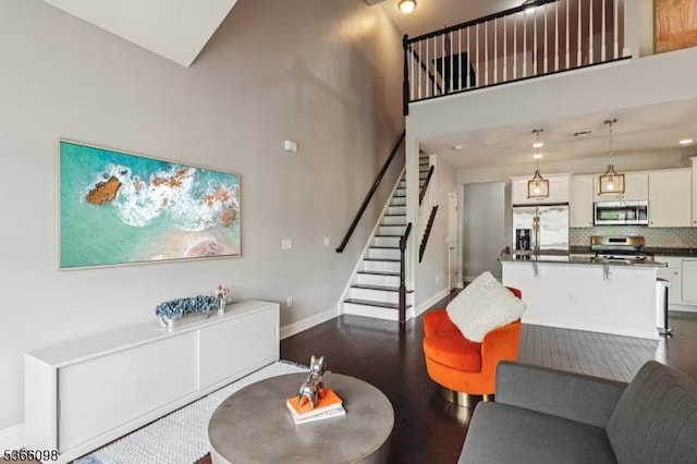 28 Elston Ct Unit 28, Wanaque Boro, NJ 07420 - living room with stairs, a towering ceiling, and dark wood-style flooring