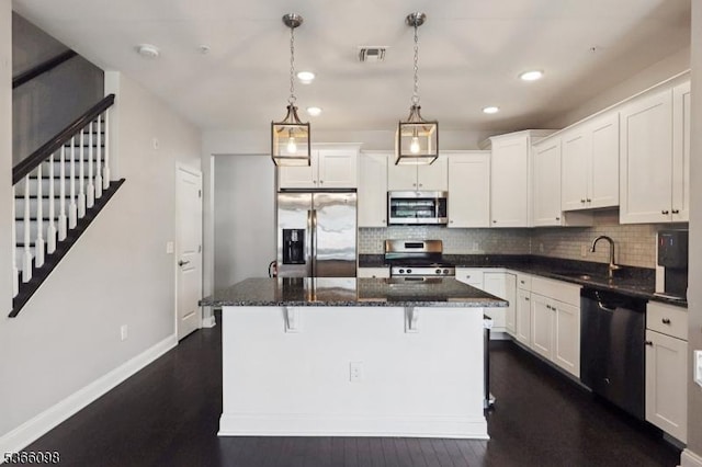 28 Elston Ct Unit 28, Wanaque Boro, NJ 07420 - kitchen with stainless steel appliances, backsplash, a center island, white cabinets, and recessed lighting