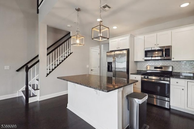 28 Elston Ct Unit 28, Wanaque Boro, NJ 07420 - kitchen featuring appliances with stainless steel finishes, recessed lighting, decorative backsplash, a center island, and white cabinetry