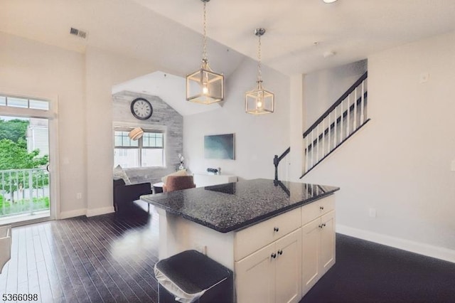 28 Elston Ct Unit 28, Wanaque Boro, NJ 07420 - kitchen with lofted ceiling, white cabinetry, dark stone countertops, decorative light fixtures, and a center island
