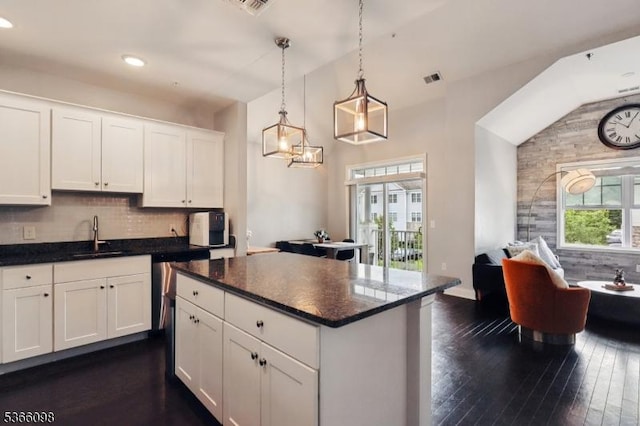 28 Elston Ct Unit 28, Wanaque Boro, NJ 07420 - kitchen with white cabinetry, dark wood-type flooring, decorative backsplash, a kitchen island, and lofted ceiling