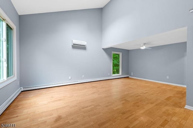 1 Lee Hill Rd, Byram Twp, NJ 07821 - empty room featuring a wall mounted AC, a baseboard heating unit, light wood finished floors, and ceiling fan