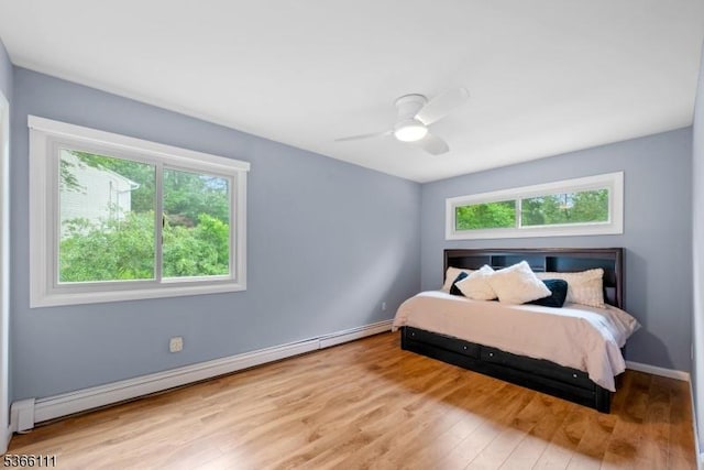 1 Lee Hill Rd, Byram Twp, NJ 07821 - bedroom with baseboard heating, multiple windows, wood finished floors, and a ceiling fan