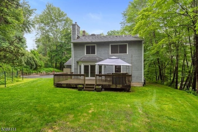 1 Lee Hill Rd, Byram Twp, NJ 07821 - rear view of property with a chimney, a wooden deck, and a lawn