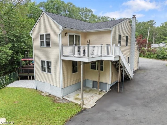 19 Elm St, Wanaque Boro, NJ 07420 - rear view of property with a deck, stairway, a chimney, a yard, and a shingled roof
