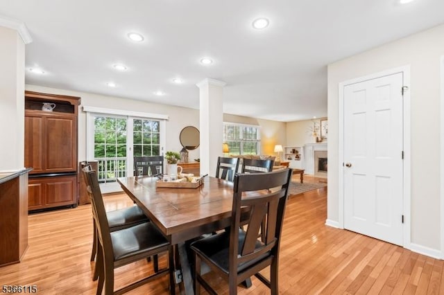 10 Cedarview Ct, Hillsborough Twp, NJ 08844 - dining area with light wood finished floors, a fireplace, recessed lighting, and decorative columns