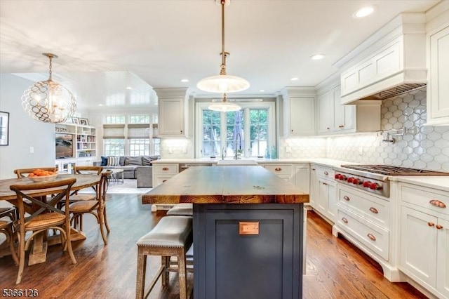 109 Chatham St, Chatham Boro, NJ 07928 - kitchen featuring stainless steel gas cooktop, white cabinets, a kitchen bar, dark wood-style flooring, and recessed lighting