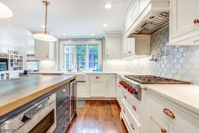 109 Chatham St, Chatham Boro, NJ 07928 - kitchen with premium range hood, stainless steel gas stovetop, white cabinetry, dark wood-type flooring, and recessed lighting