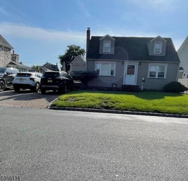 136 N 21st St, Kenilworth Boro, NJ 07033 - view of front of house featuring decorative driveway, a front yard, and a chimney