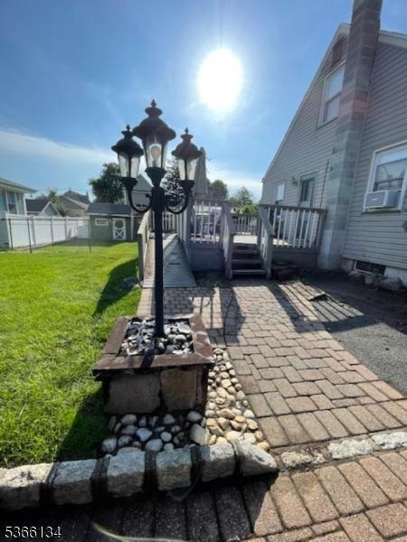 136 N 21st St, Kenilworth Boro, NJ 07033 - view of patio with an outdoor fire pit, a deck, and cooling unit