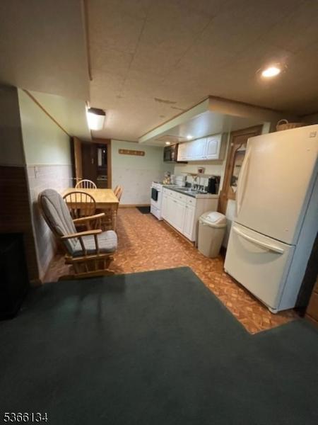 136 N 21st St, Kenilworth Boro, NJ 07033 - kitchen with freestanding refrigerator and white cabinetry
