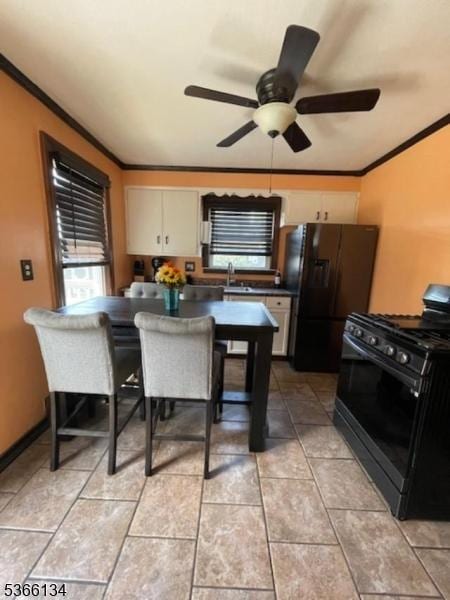 136 N 21st St, Kenilworth Boro, NJ 07033 - kitchen with black appliances, ornamental molding, ceiling fan, dark countertops, and light tile patterned floors