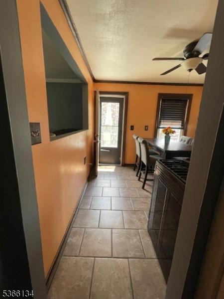 136 N 21st St, Kenilworth Boro, NJ 07033 - doorway featuring baseboards and ceiling fan