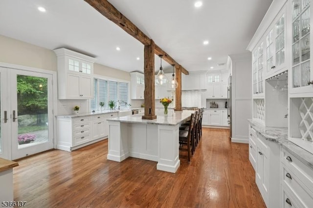 4 Knollwood Ln, Hardyston Twp, NJ 07460 - kitchen featuring a kitchen island, recessed lighting, white cabinetry, wood finished floors, and light stone counters